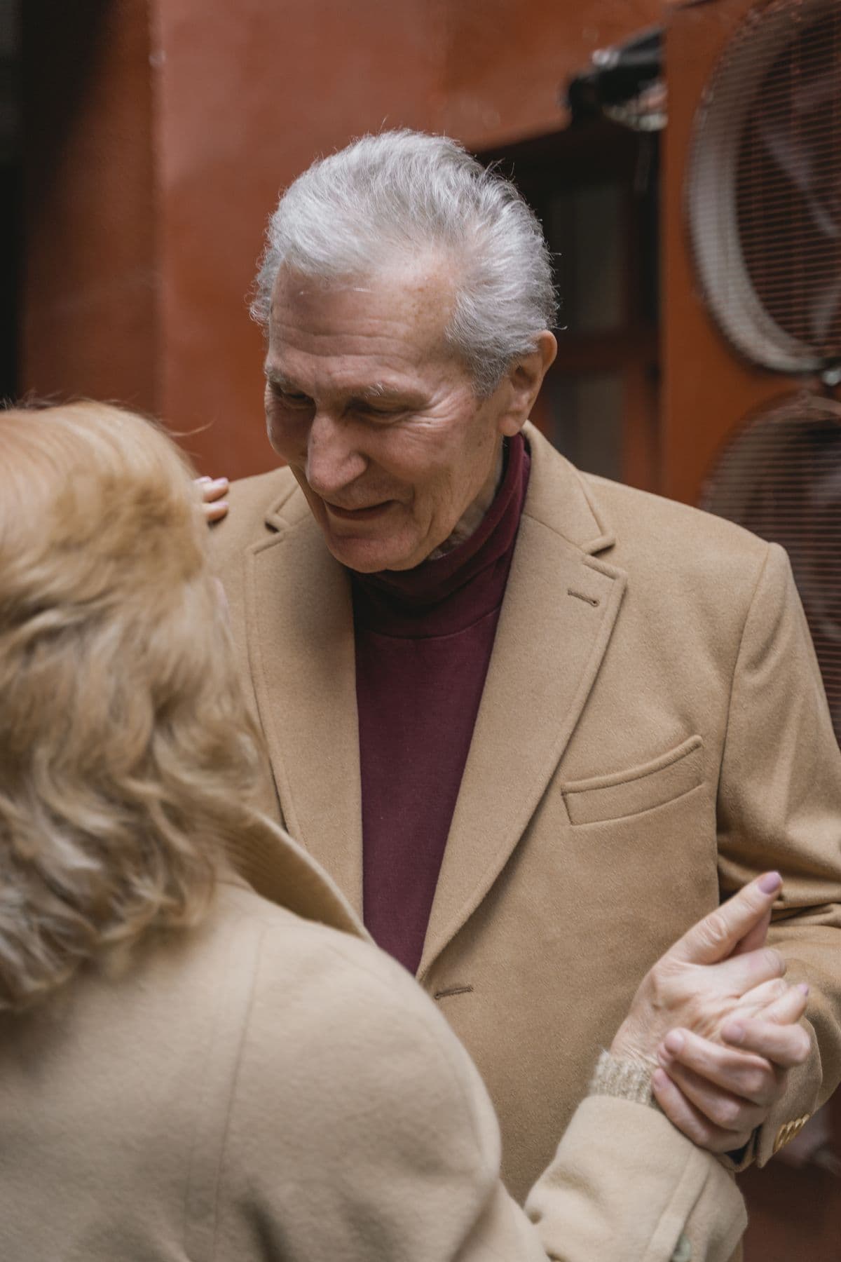 An elderly couple dancing close together